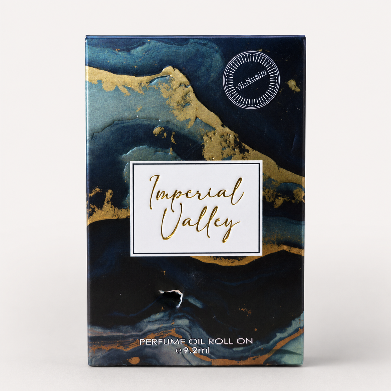 Perfume oil roll on packaging with 'Imperial Valley' branding on a blue and gold marbled background.