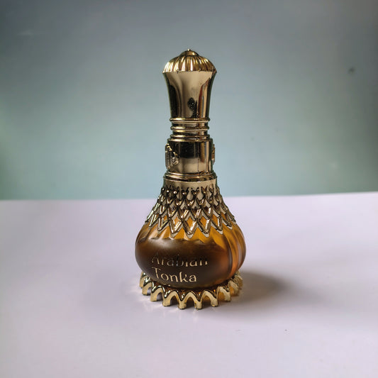 Decorative bottle with gold accents on a white surface and light gray background