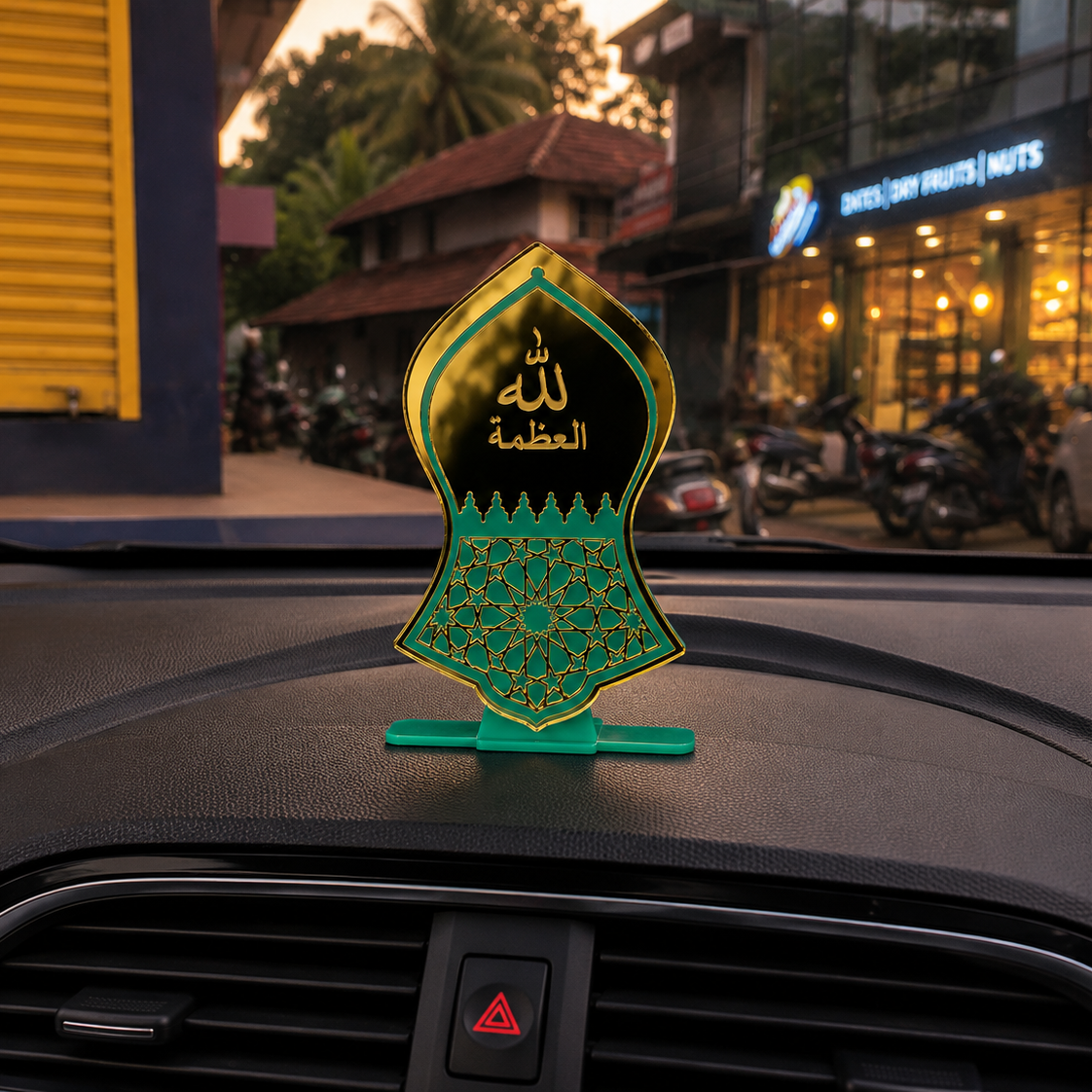 Decorative car emblem on a car dashboard with a city street background